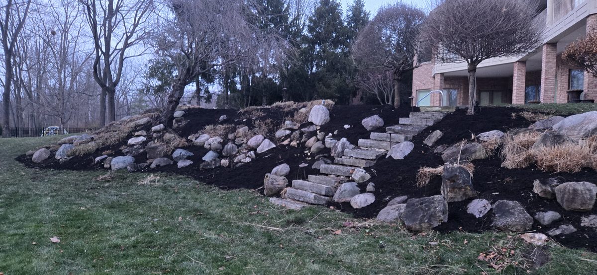 Large boulder retaining wall installation