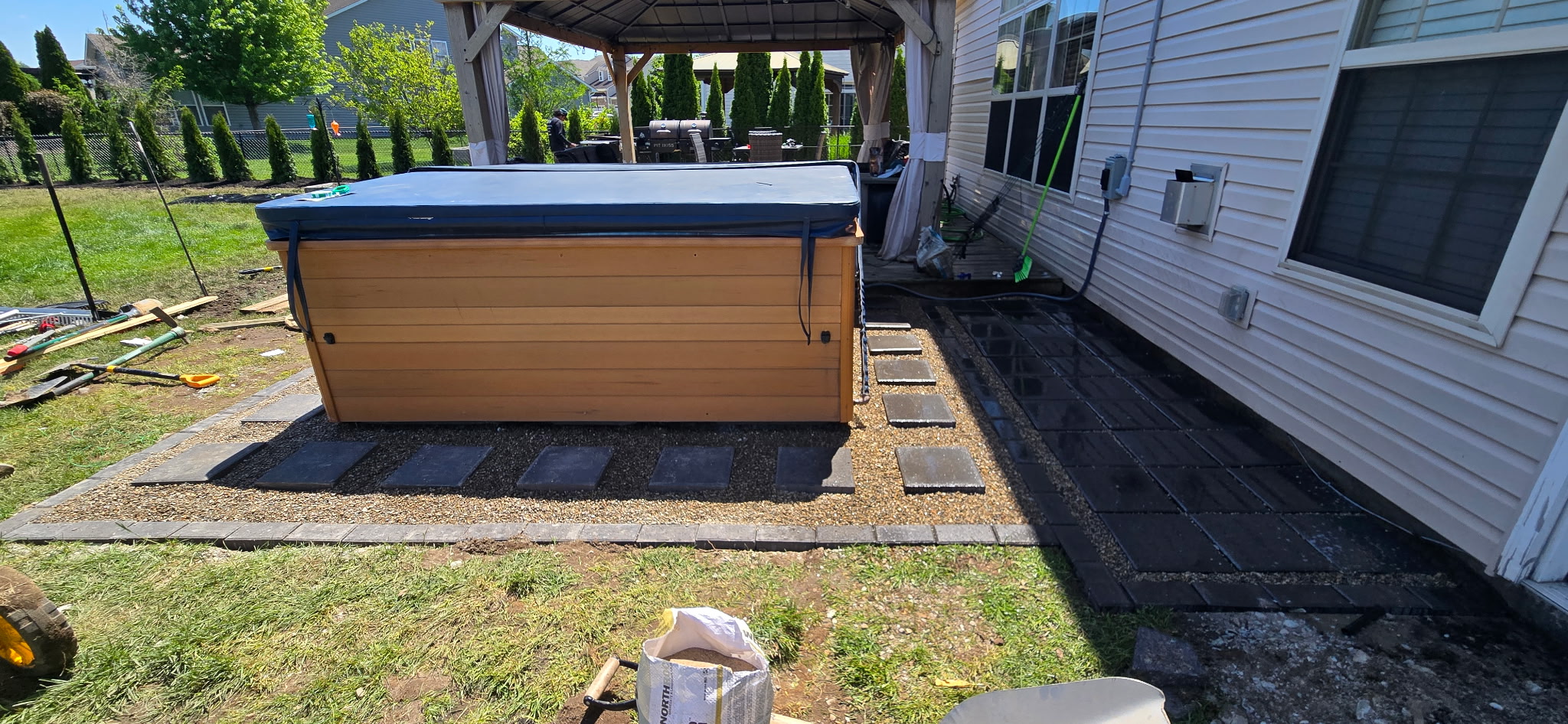 Wide angle of paver patio project with gazebo