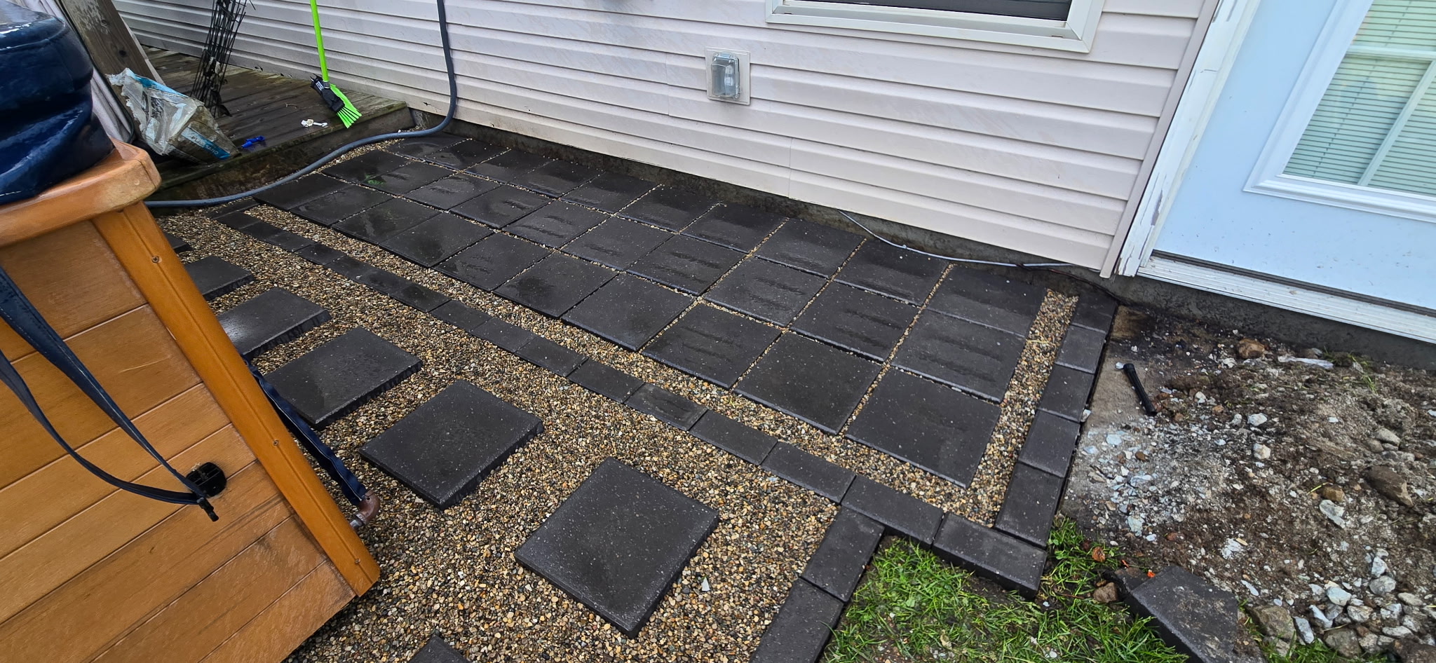Close-up of dark paver patio installation