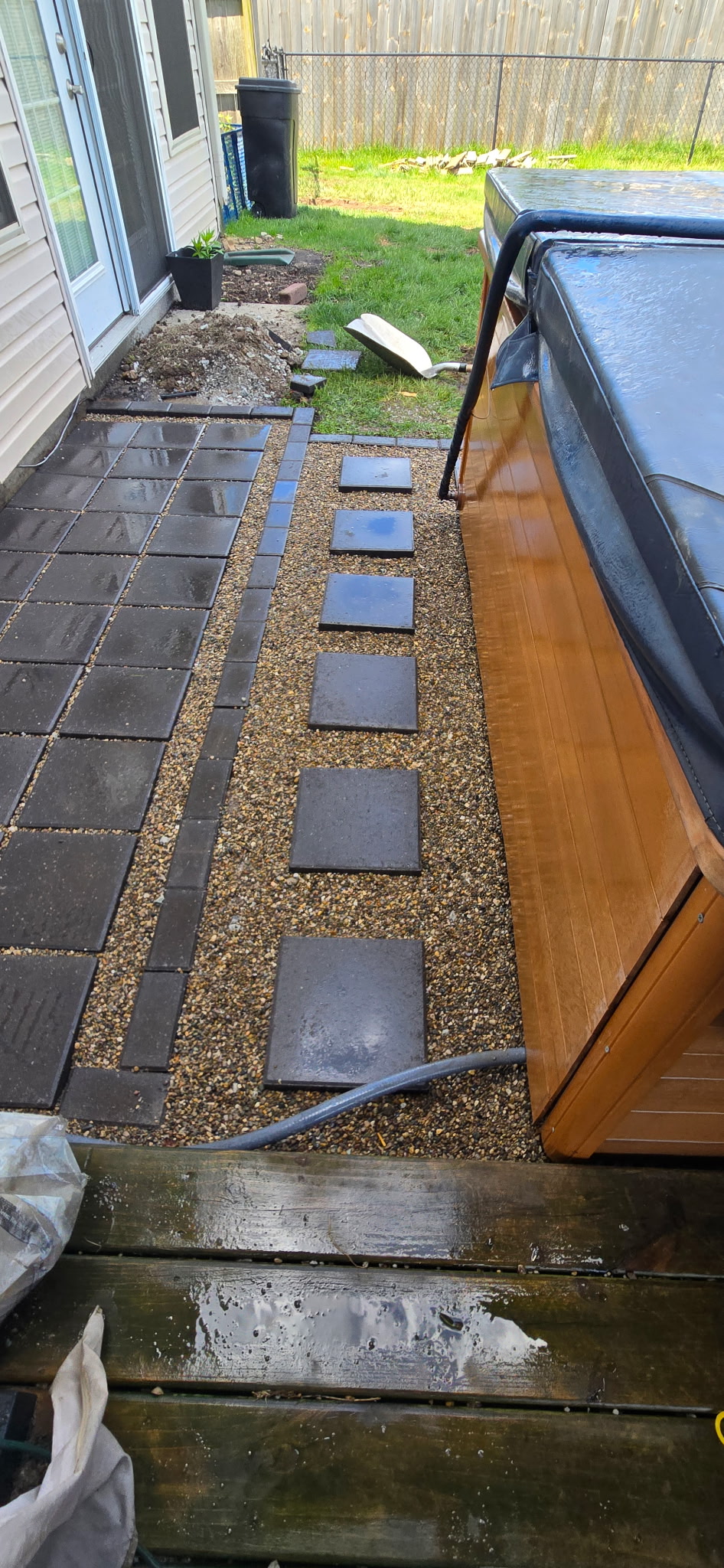 Close-up of stepping stones and pavers along hot tub
